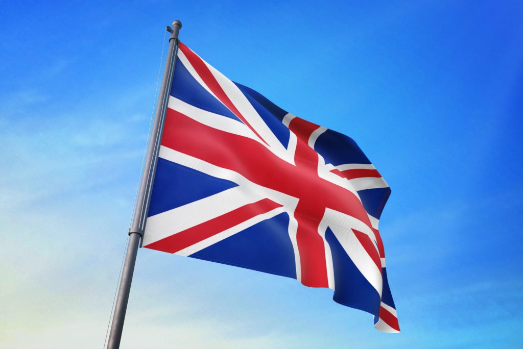 United Kingdom flag waving in the blue sky