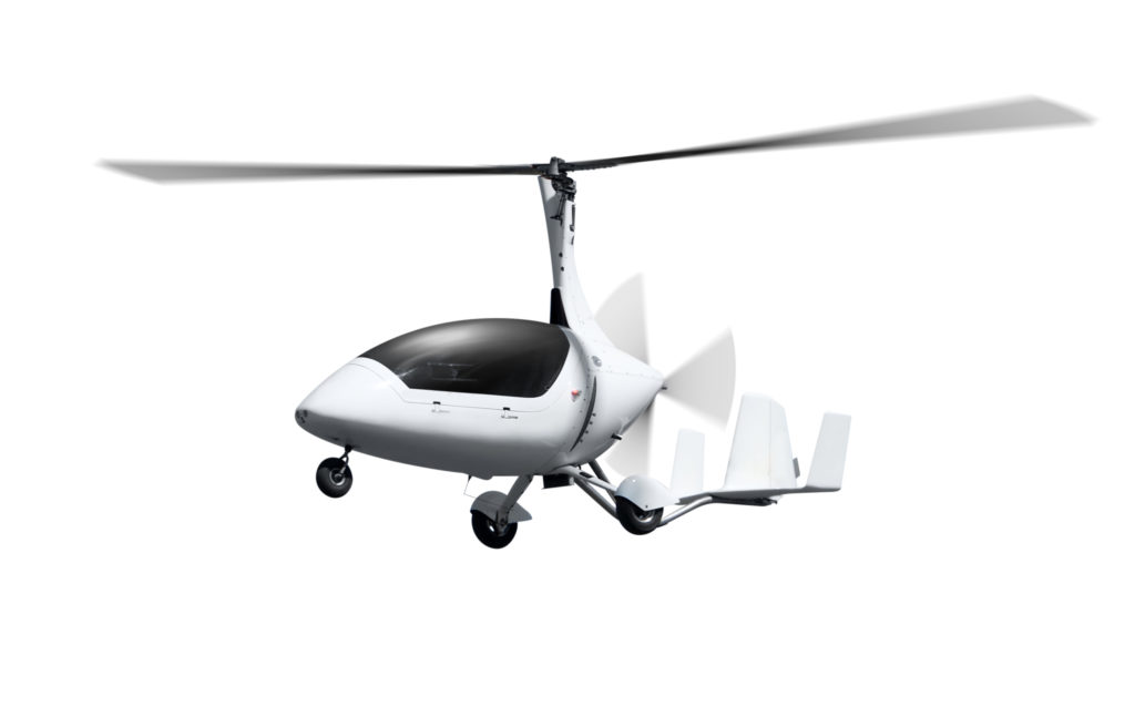 Autogyro in flight with rotating propellers